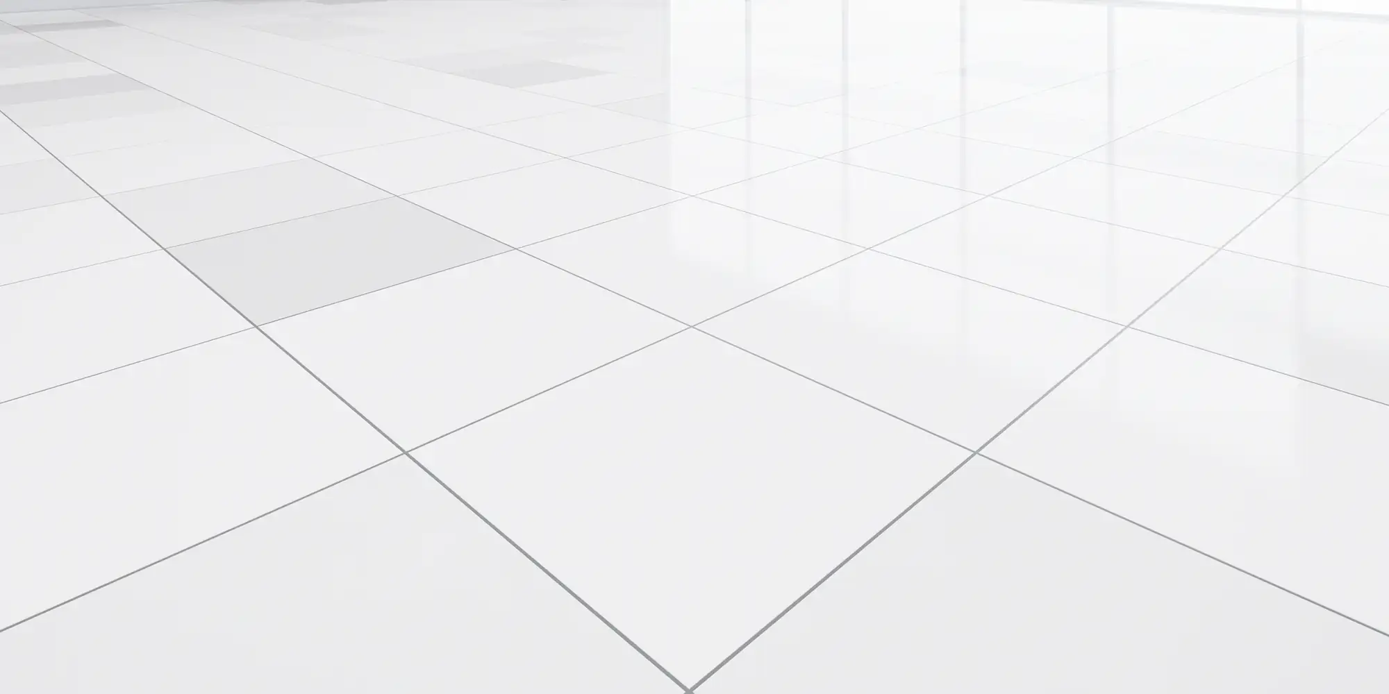 Shiny white tiled floor in a bright, empty room displays window reflections on the gleaming surface.